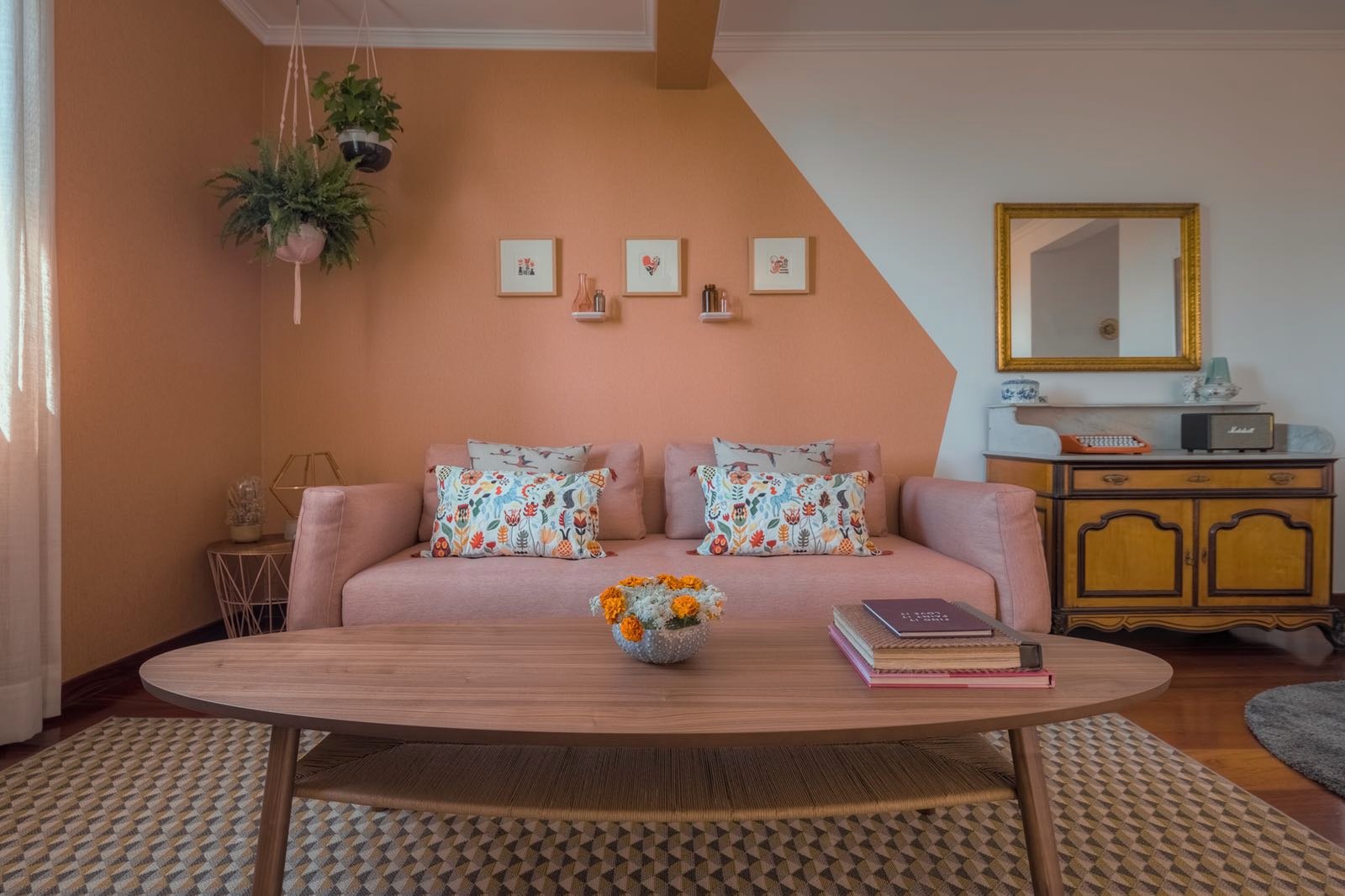 Santa Catarina Apartment — living room with a terracotta-pink wall, pink sofa and oval coffee table